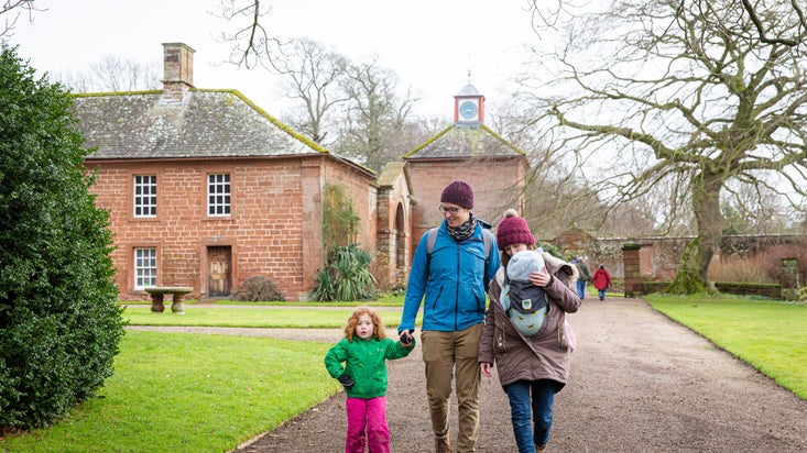 A family exploring the garden at Acorn Bank, Cumbria